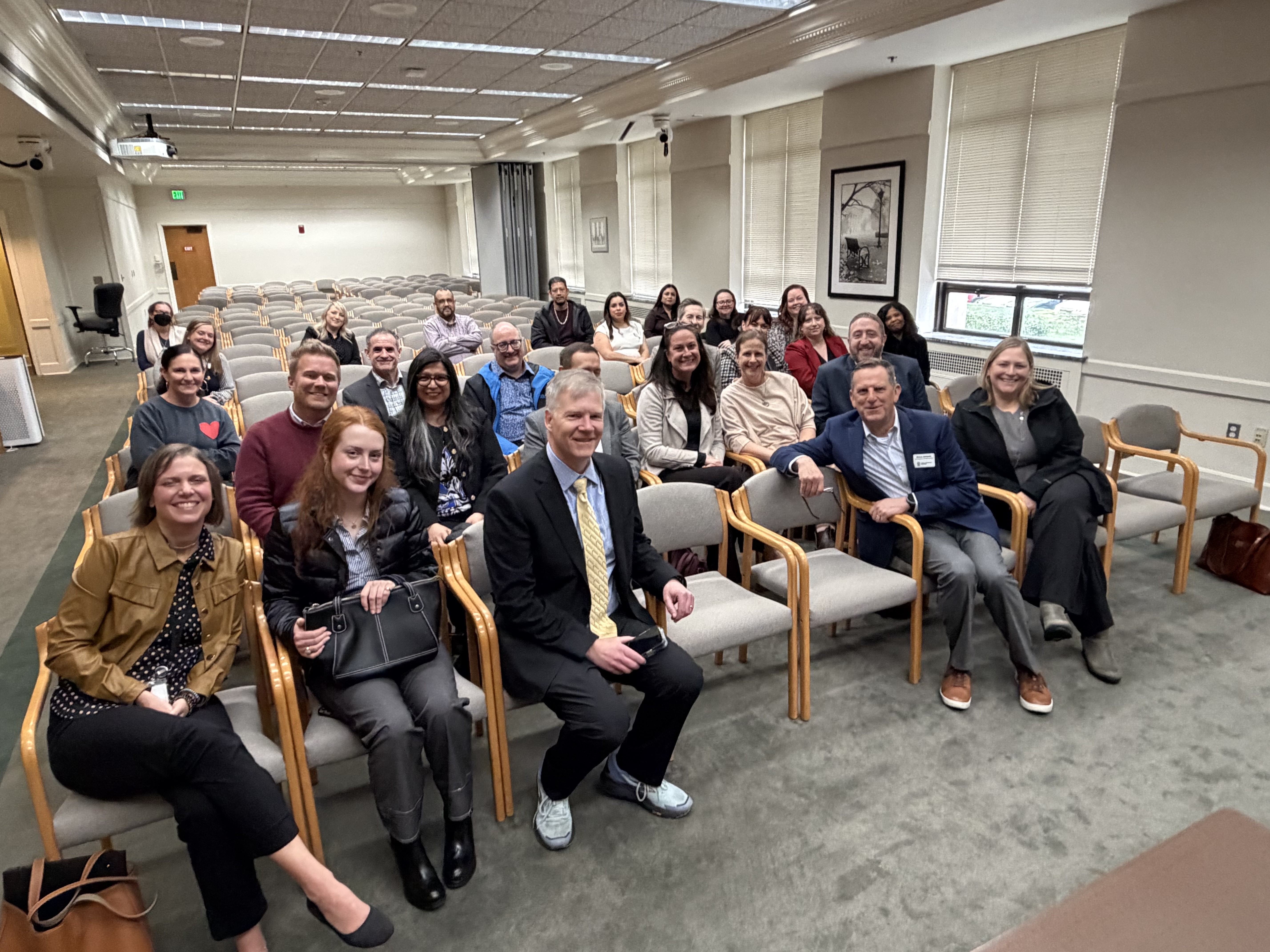 Student services VPs sit in a hearing room with Rep. Dave Paul
