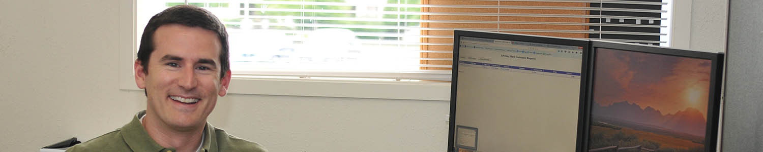 Teacher smiles at his desk