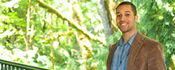 Man in front of trees