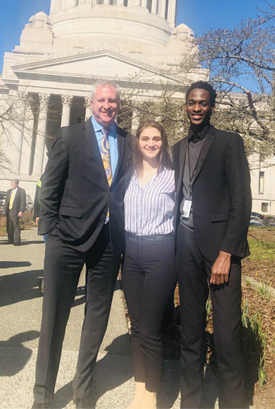 Mustapha, Kristina and Arlen Harris in front of the Legislative Building