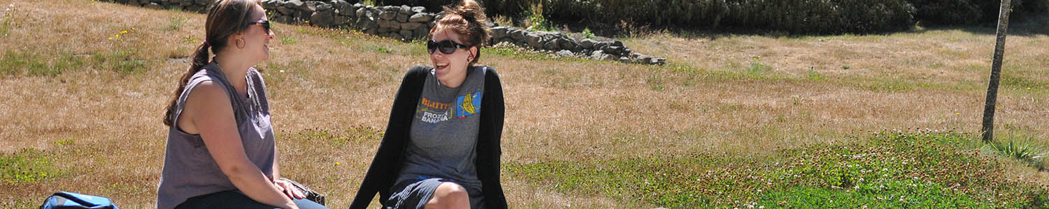 Two females students relaxing outdoors