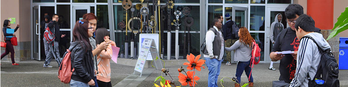 Students mingle near kinetic sculpture at South Seattle College