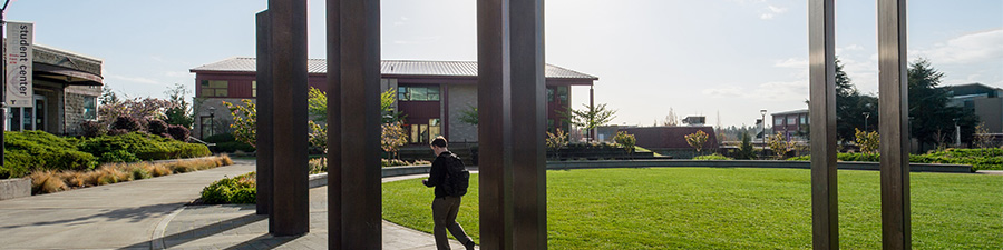 Tacoma Community College campus with student walking outside