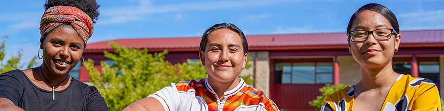 Three students sitting outside