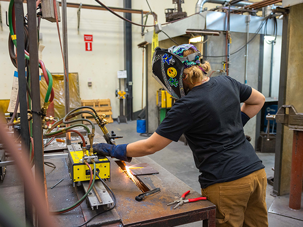 Welding student working at a welding station